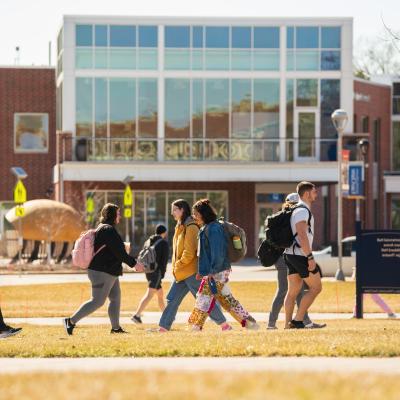 campus scene fall , students passing on the mall 